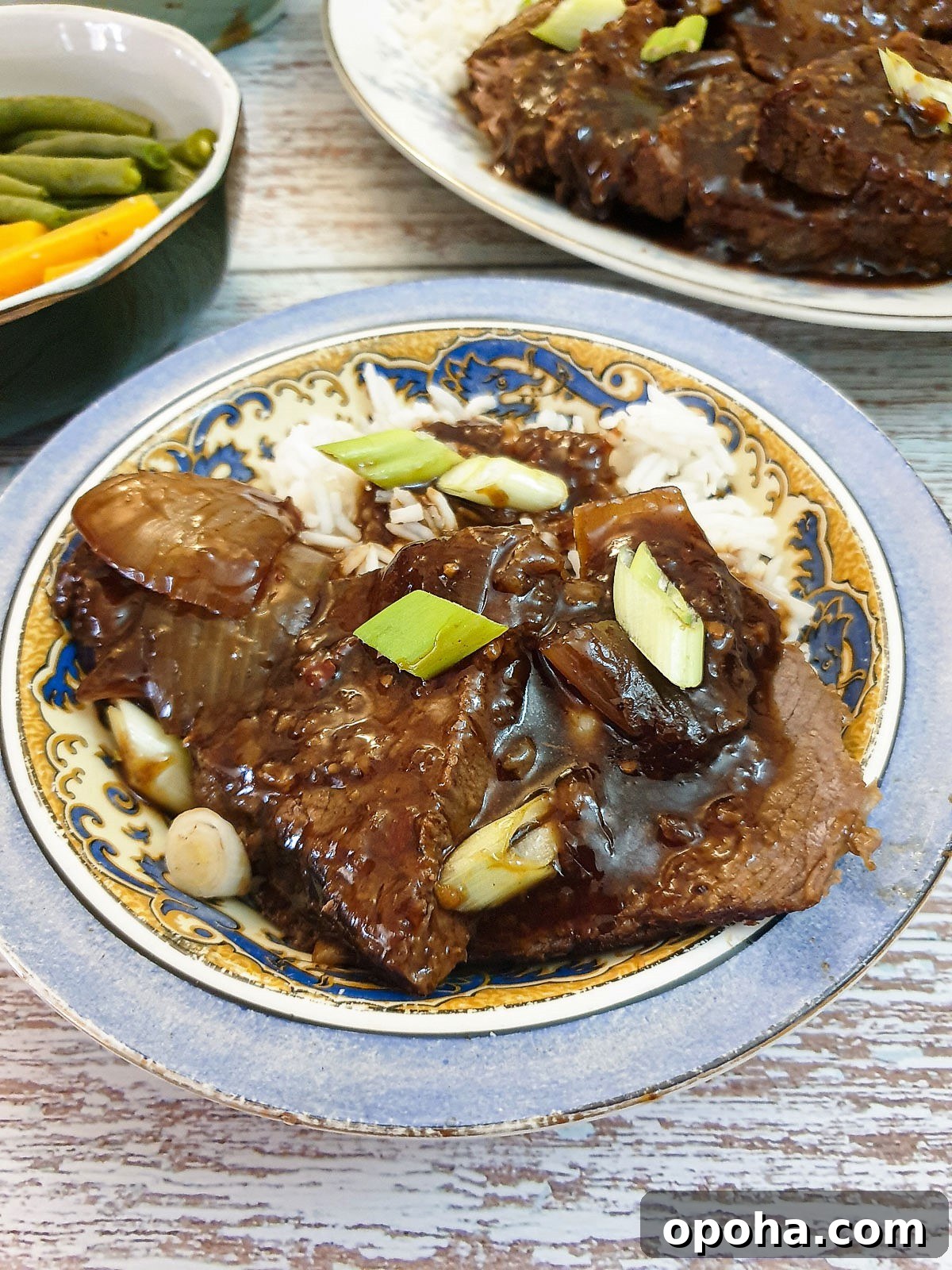 Slow-Cooker Mongolian Roast Beef Recipe for Tender, Savory Meat 3 A dish of slices of mongolian roast beef with rice.