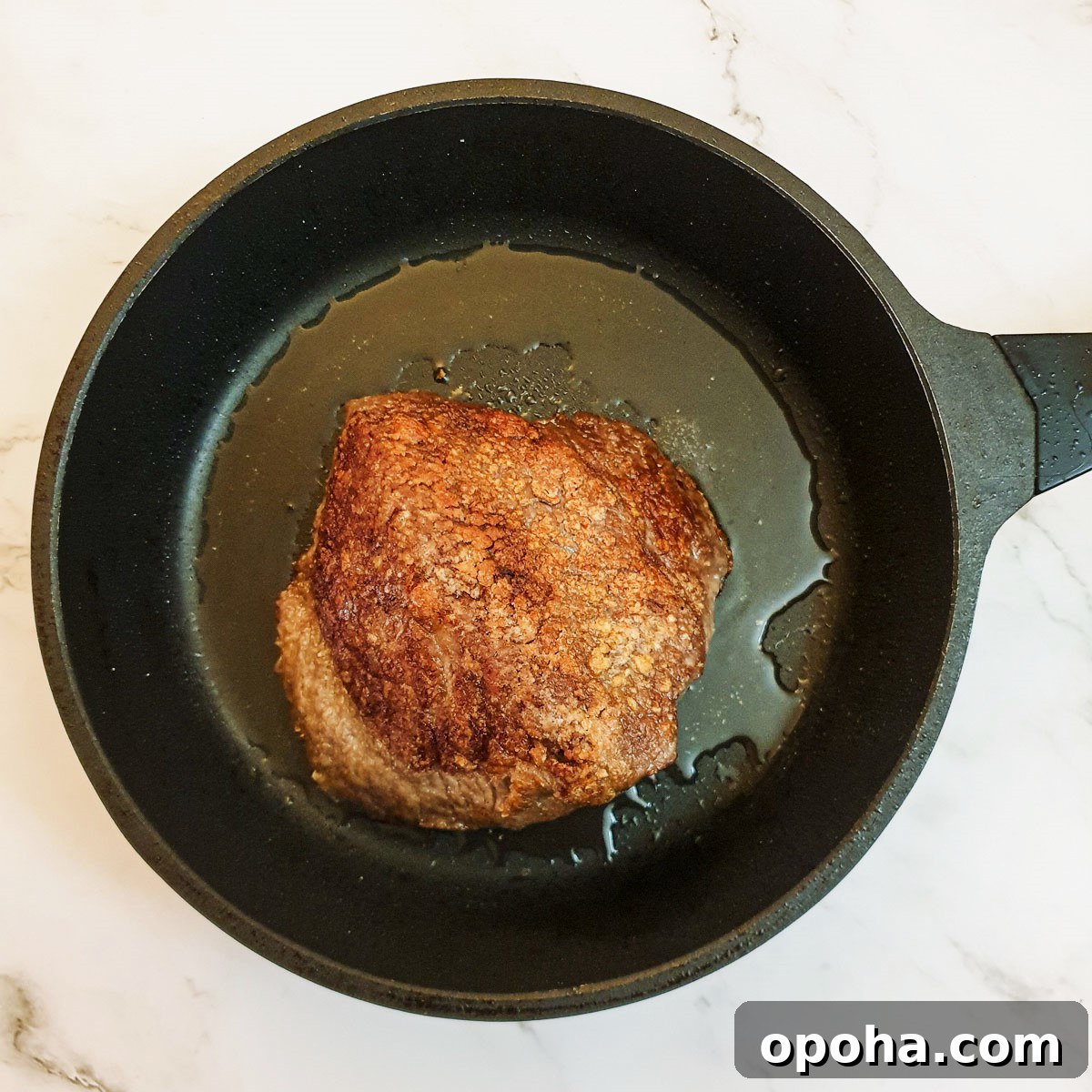 Slow-Cooker Mongolian Roast Beef Recipe for Tender, Savory Meat 6 A small beef joint browning in a frying pan.