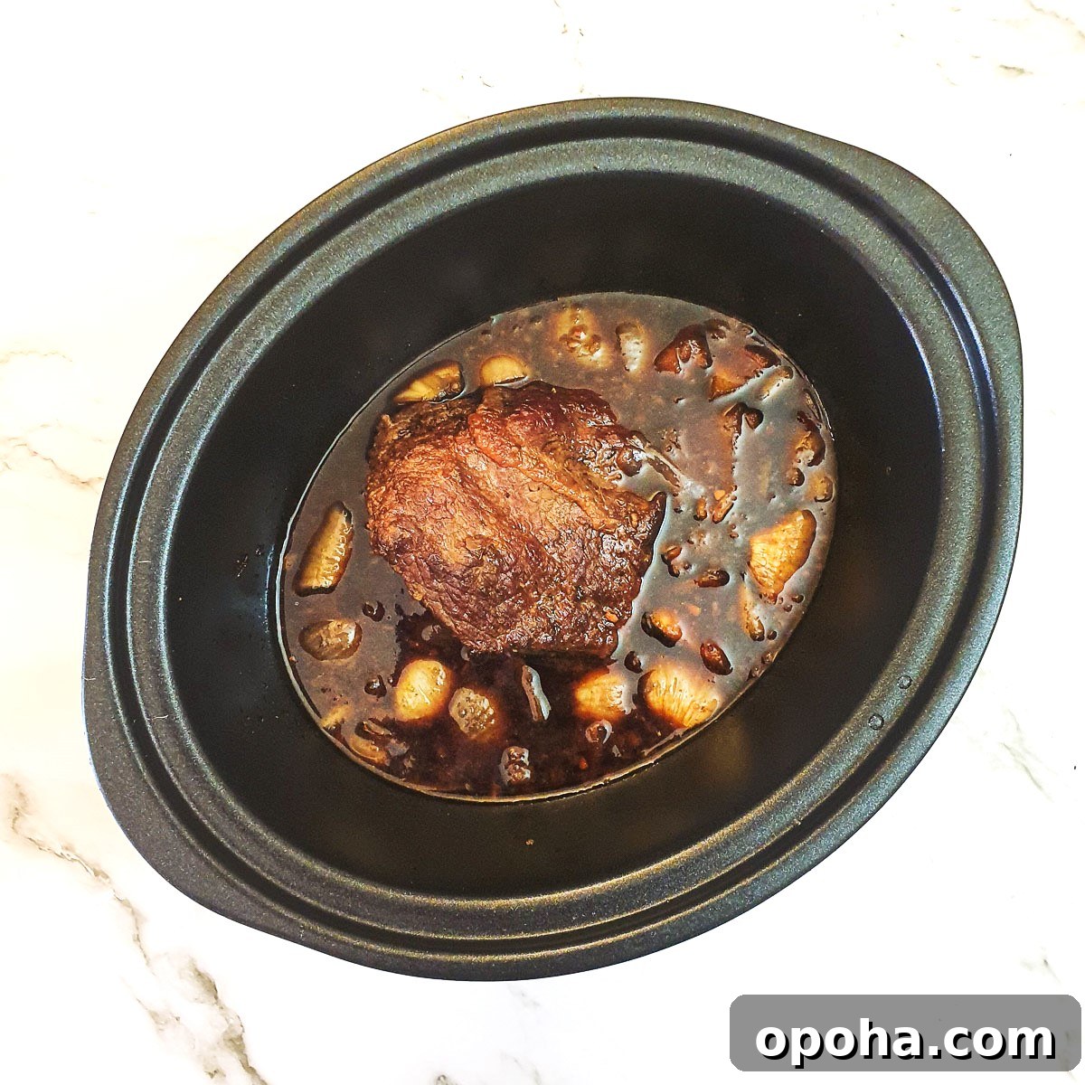 Slow-Cooker Mongolian Roast Beef Recipe for Tender, Savory Meat 8 A cooked beef joint in a slow cooker.