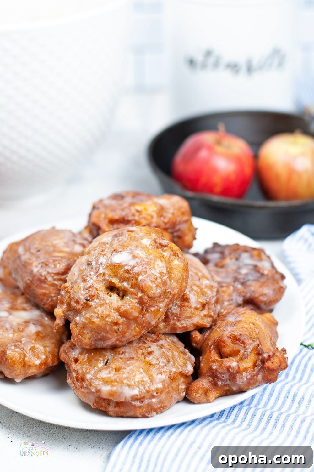 Close up image of fried homemade apple fritters with sugar glaze