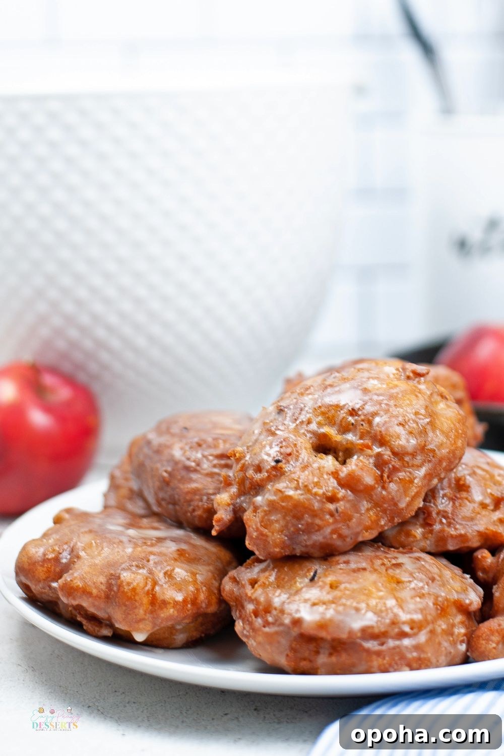 Close up image of apple fritters in a white serving plate
