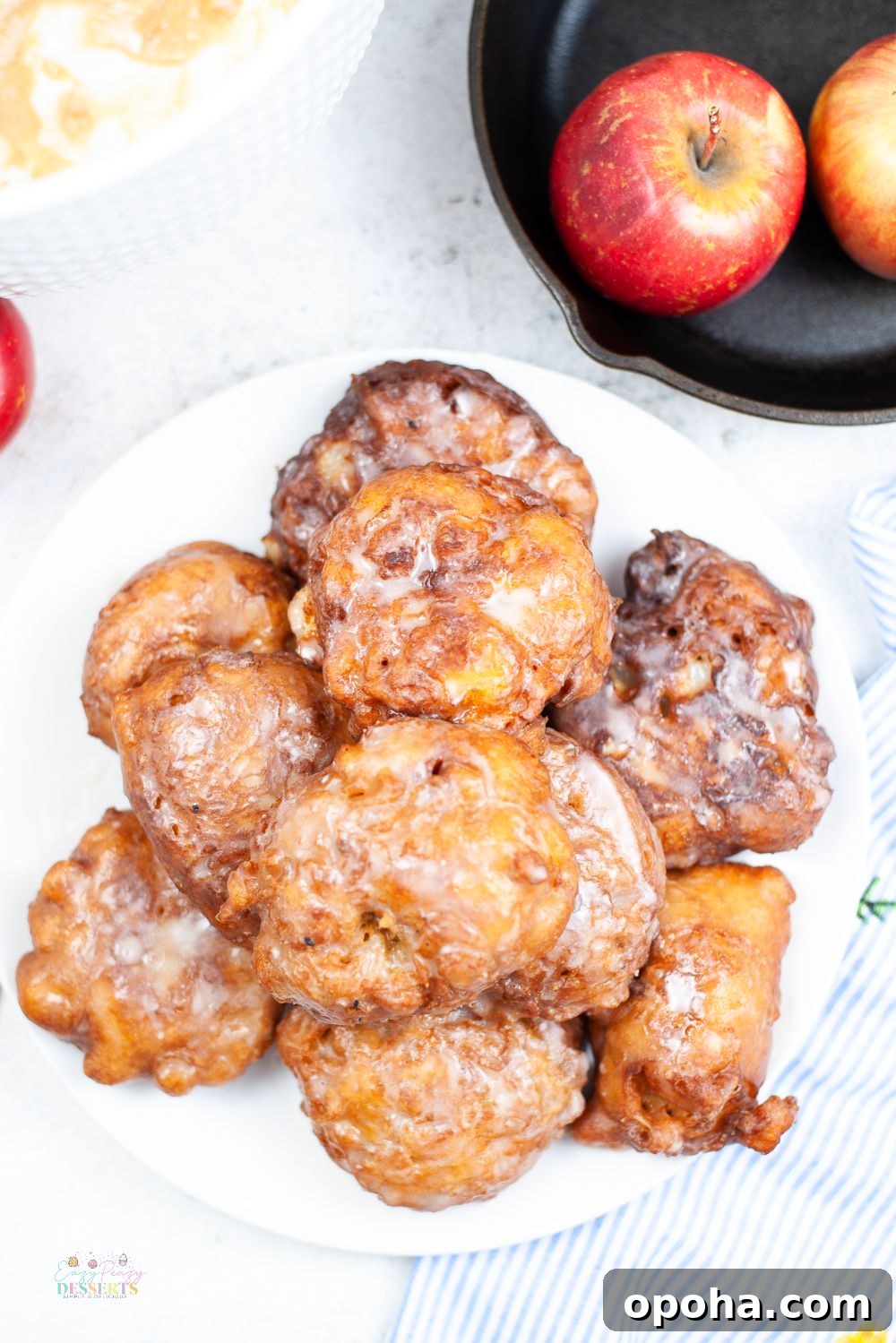 Overhead image of homemade easy apple fritters in a white serving plate