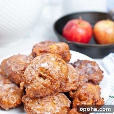 Close up image of fried homemade apple fritters with sugar glaze