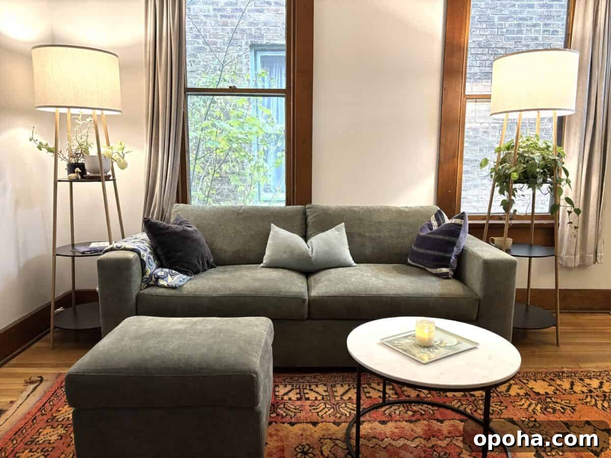 a beautiful Rio Sofa from Medley with lamps on each side and a small circular table with scented candle in front of it