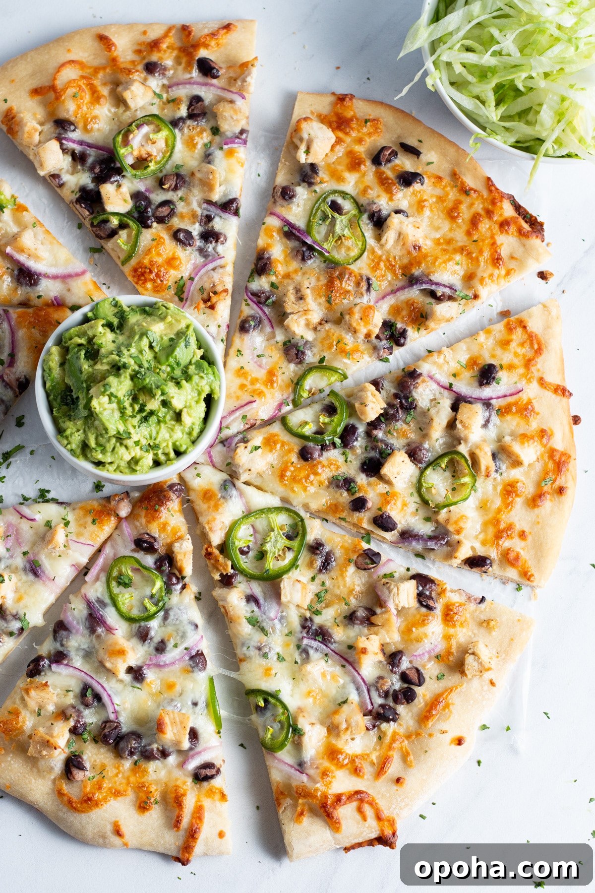 Chicken, Black Bean & Smashed Avocado Pizza Recipe 2 This is picture of pizza with chicken ,black beans, cheese, onion and jalapeño with a little bowl of smashed avocado.