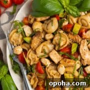 This is a picture of a plate of chicken tortellini caprese salad.