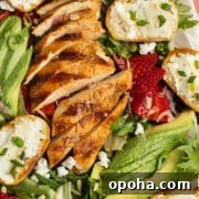 This is a picture of the grilled chicken salad with goat cheese, avocado and strawberries.