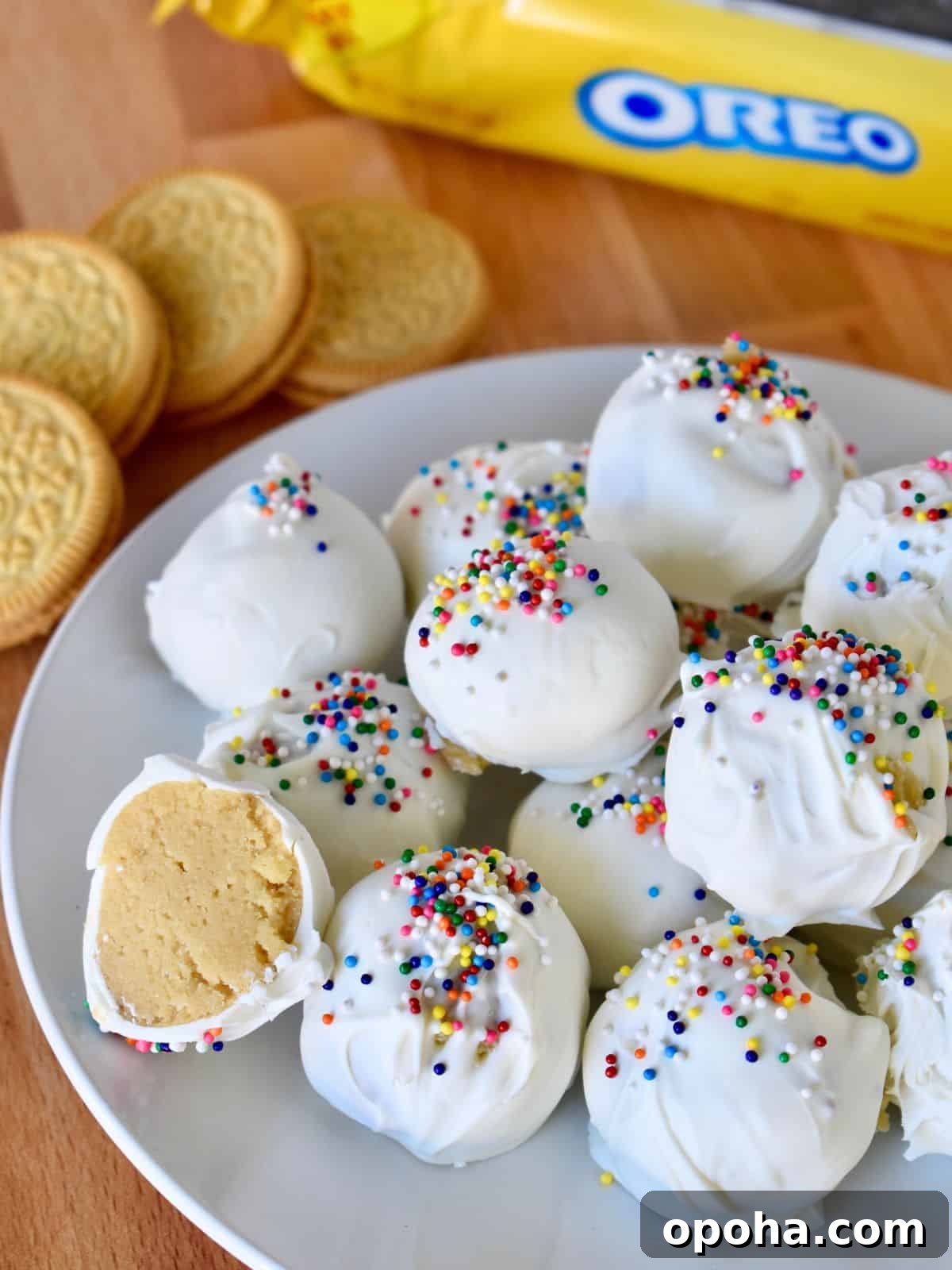 Golden Oreo Truffles: How to Make Classic Oreo Cookie Balls 2 Golden Oreo Truffles on a plate with a yellow Oreo bag in the background.