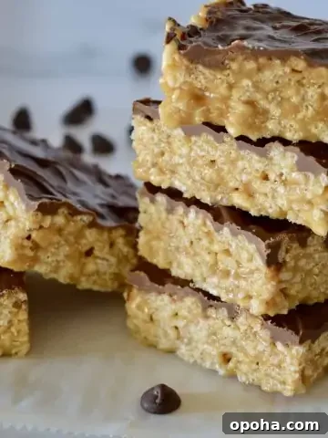 Caramel Peanut Butter Krispies staked on a white countertop.
