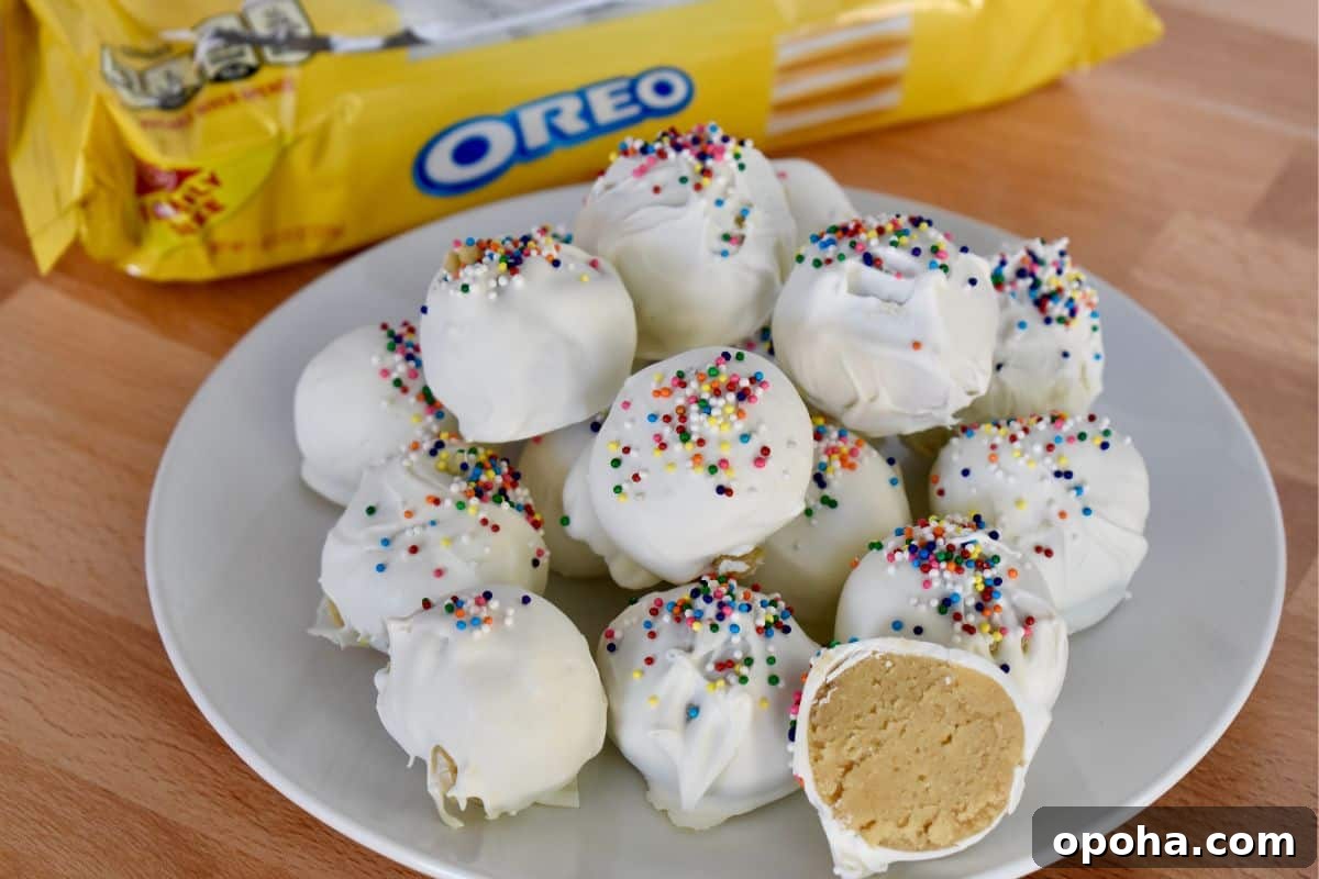 Golden Oreo Truffles: How to Make Classic Oreo Cookie Balls 3 Golden Oreo Truffles on a white plate with oreo package in the background.