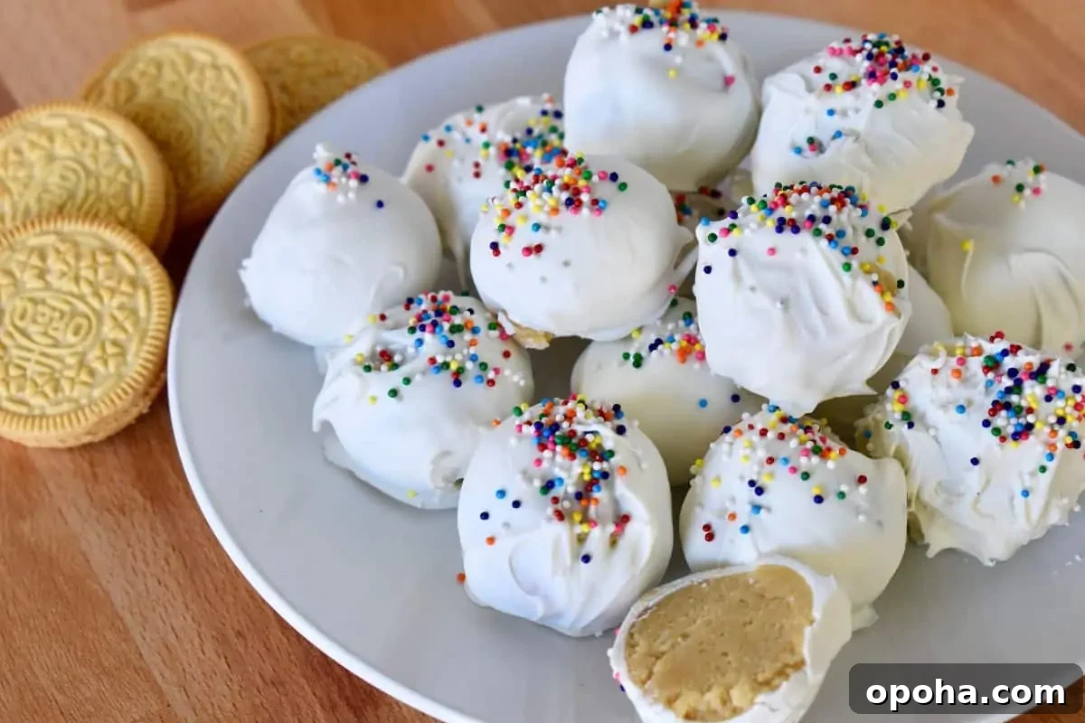 Golden Oreo Truffles: How to Make Classic Oreo Cookie Balls 6 Golden Oreo Truffles on a white plate with cookies next to the plate.