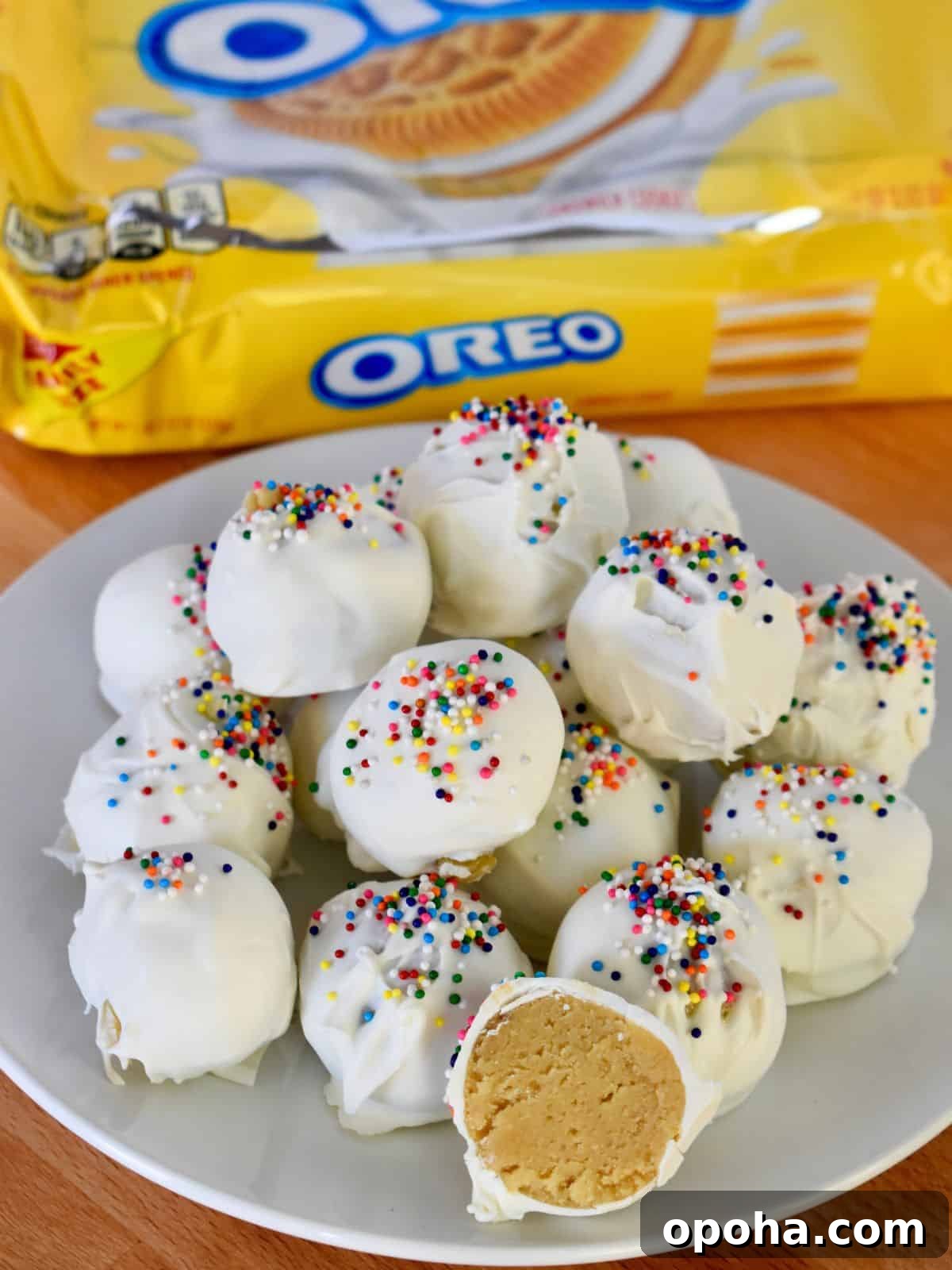 Golden Oreo Truffles: How to Make Classic Oreo Cookie Balls 7 Golden Oreo Truffles on a white plate with a package of Golden Oreos in the background.