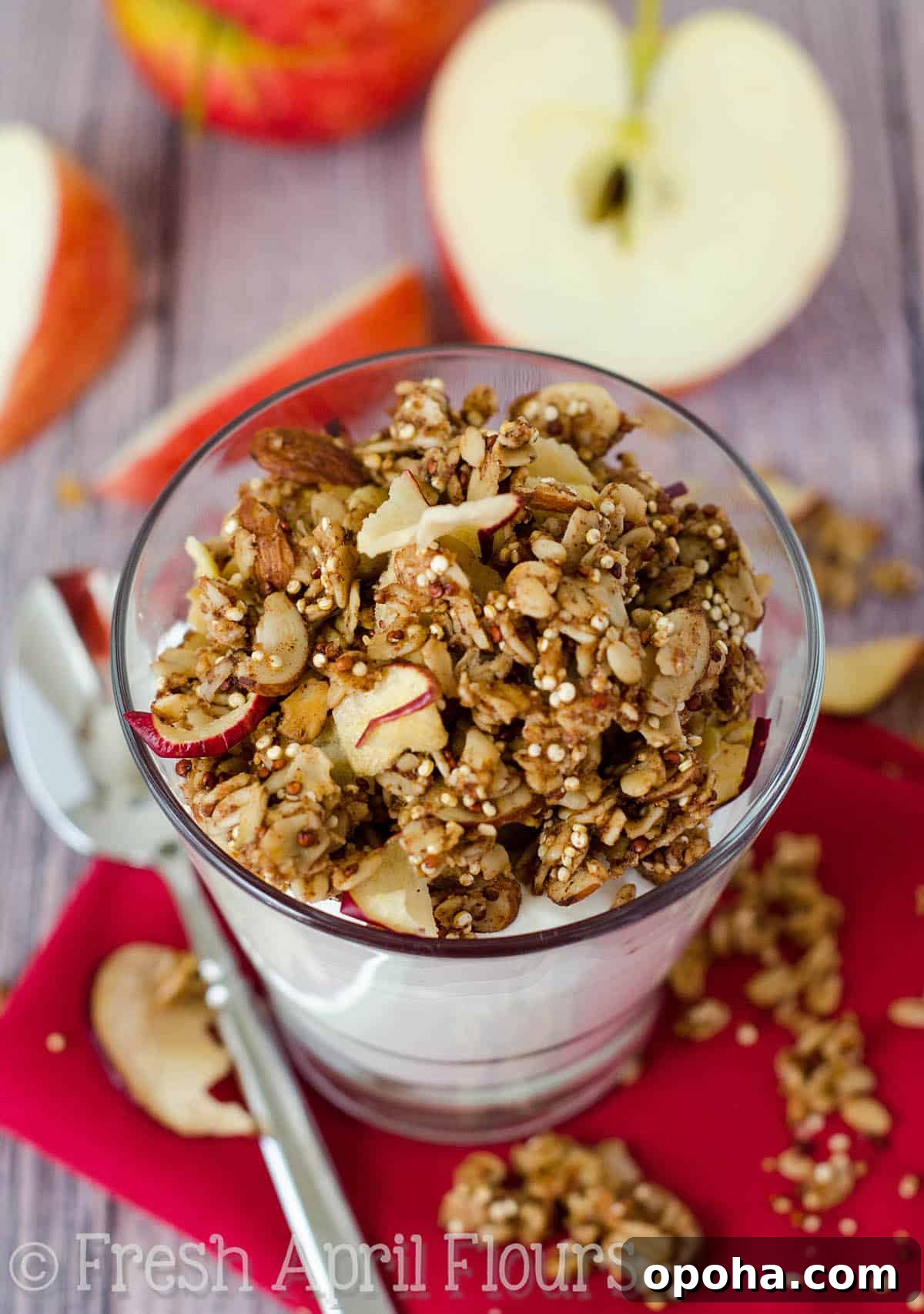 Apple Quinoa Granola Recipe: Crunchy Baked Apple Quinoa Clusters 6 Apple quinoa granola on top of a cup of yogurt.