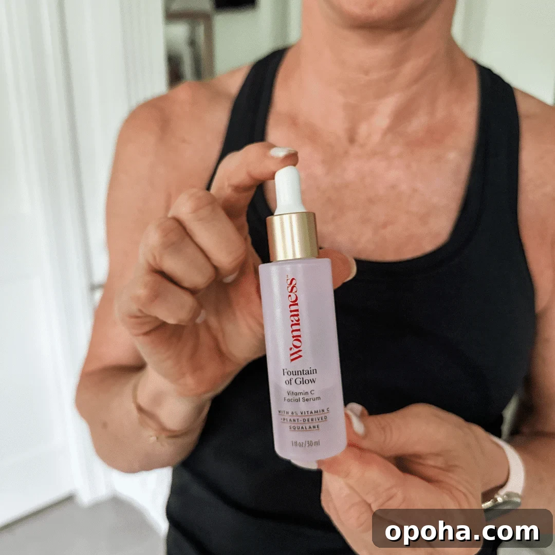 Top Anti-Aging Skincare Picks for Women Over 50 3 Woman holding onto a bottle of Womaness Foundation of Glow Vitamin C Serum