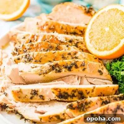 Juicy Slow-Cooker Turkey Breast Recipe for Tender Results 9 Sliced turkey breast on a white plate.