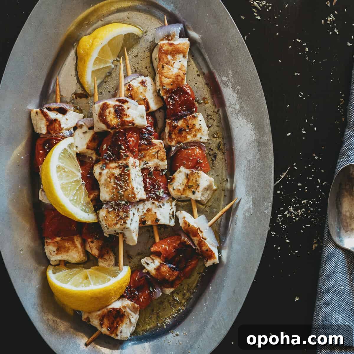 a plate filled with souvlaki made form swordfish