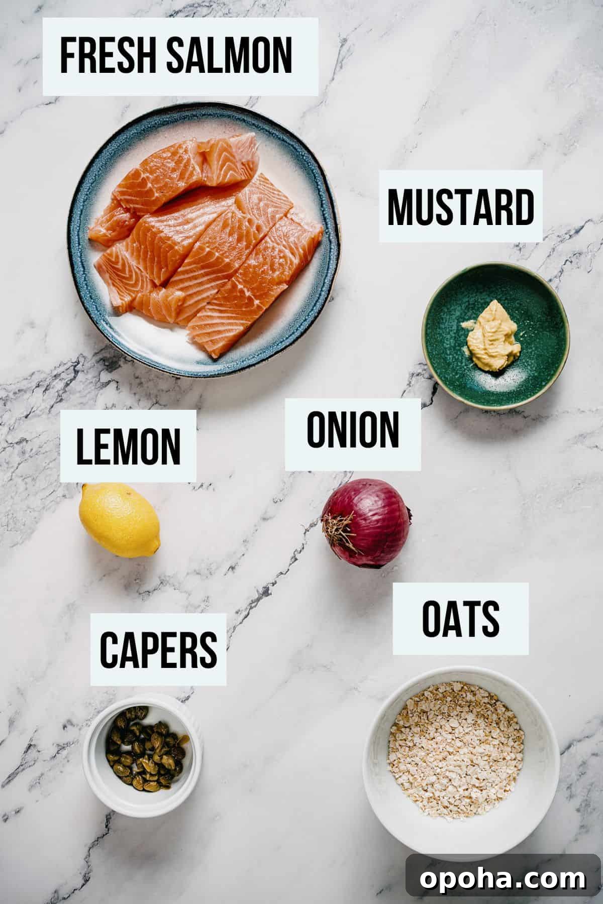 a marble table with ingredients to make grilled salmon burgers.