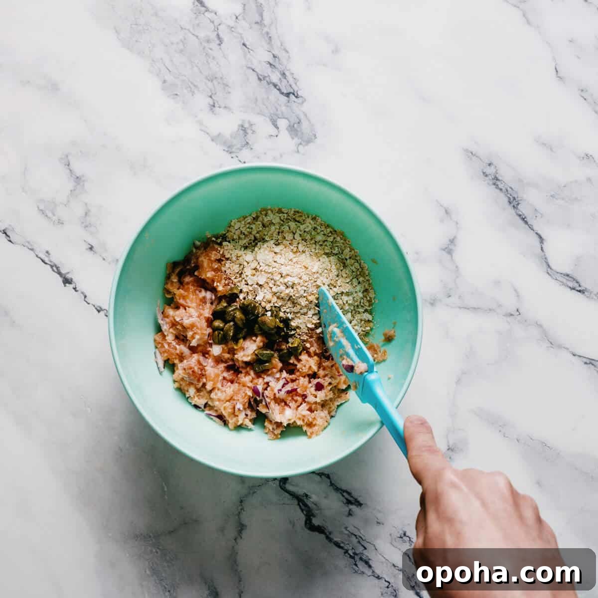 a bowl with ingredients to make salmon burgers.