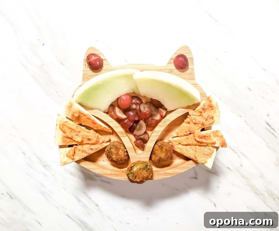 Baby-Led Weaning Meal Ideas: What Theo Loves to Eat 6 A fox plate for my son's lunch. It features honeydew, grapes, veggie nuggets and hummus on naan bread. The plate is sitting on a marble table.