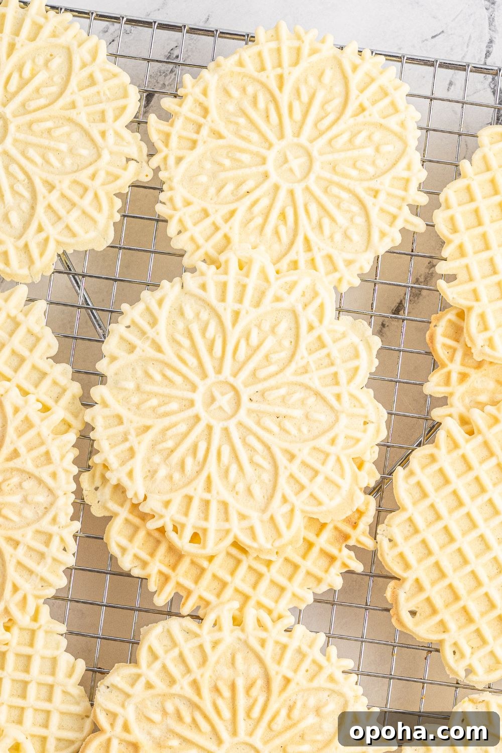 Traditional Italian Pizzelle Cookies: Crisp Anise Wafers Recipe 22 Pizzelle cookies stacked on a cooling rack