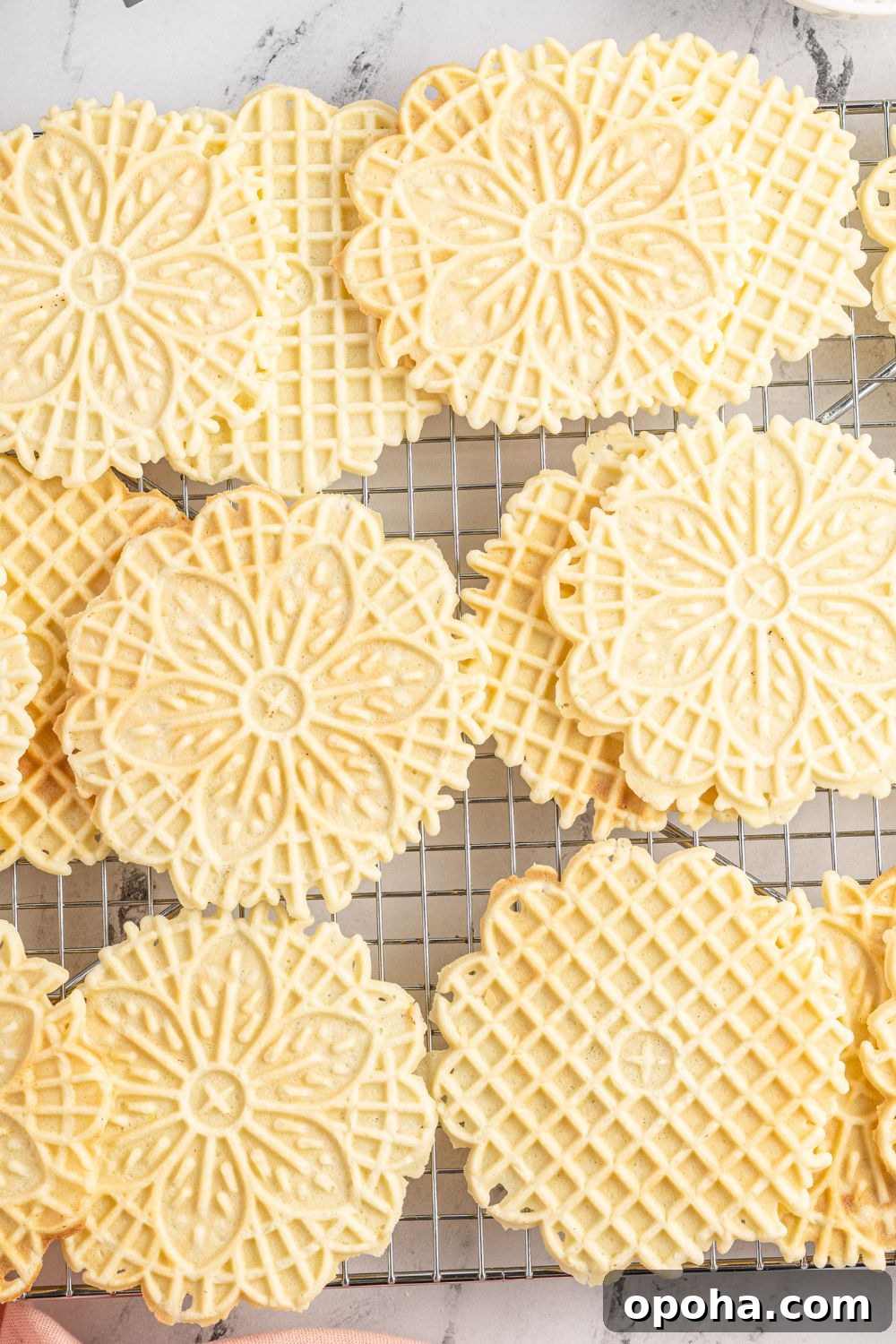 Traditional Italian Pizzelle Cookies: Crisp Anise Wafers Recipe 4 pizzelle cookies on a cooling rack