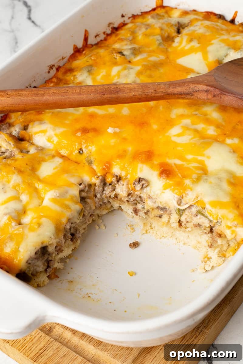 Philly Cheesesteak Casserole with Ground Beef — Savory Comfort Bake 14 Casserole dish with a piece of philly steak casserole removed from the dish.