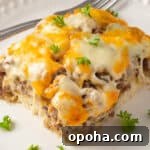 Serving of Philly cheesesteak casserole on a white plate with a fork.