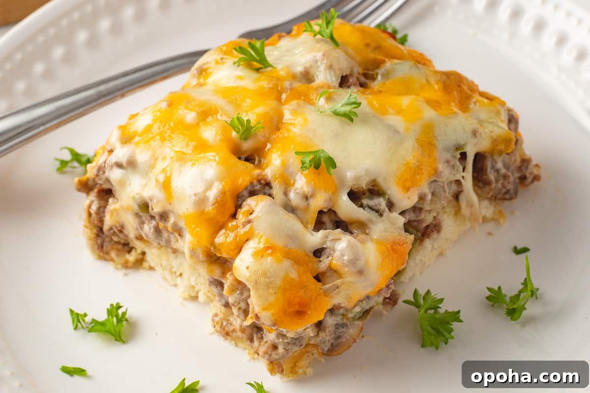 Philly Cheesesteak Casserole with Ground Beef — Savory Comfort Bake 3 Single serving of philly cheesesteak casserole on a white plate with a fork.
