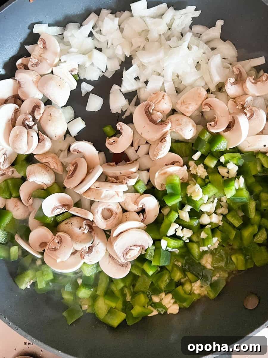 Philly Cheesesteak Casserole with Ground Beef — Savory Comfort Bake 8 Garlic, onion, mushroom and green peppers in large skillet with olive oil.