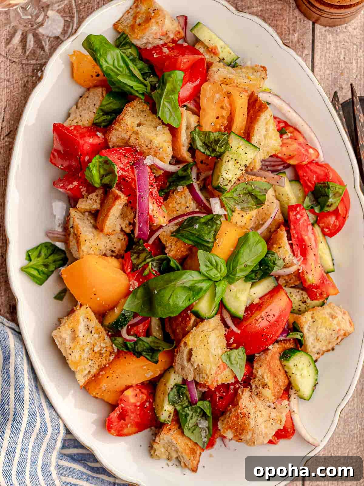 Tuscan Panzanella Salad: Classic Bread & Tomato Recipe 6 Panzanella salad on a white platter.