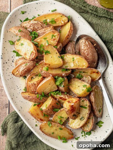 A spoon scooping potato salad on a plate.