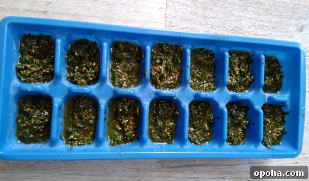 Freeze Fresh Basil in Ice Cube Trays: Step-by-Step Guide 4 ice cube tray filled with basil mixture.