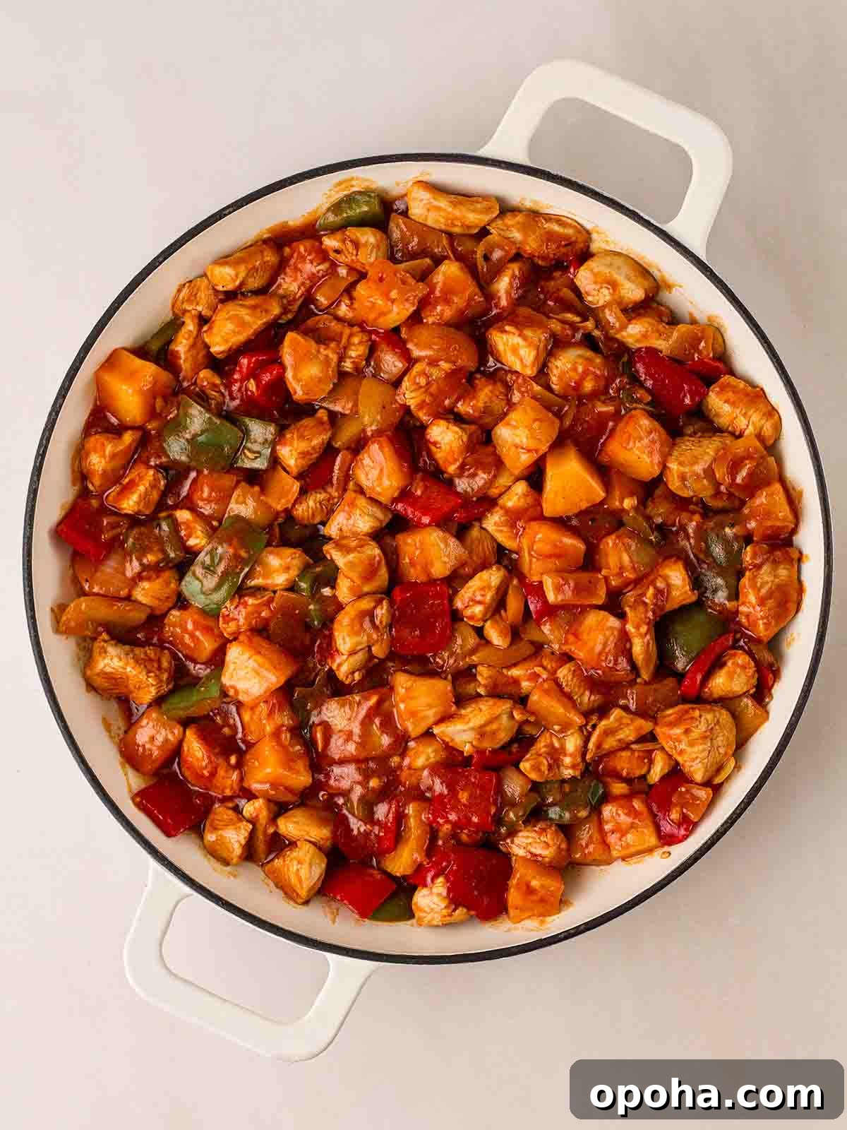 Sweet and Sour Chicken Recipe — Quick Home-Style Version 7 A large white pan filled with cooked Sweet and Sour Chicken dish.