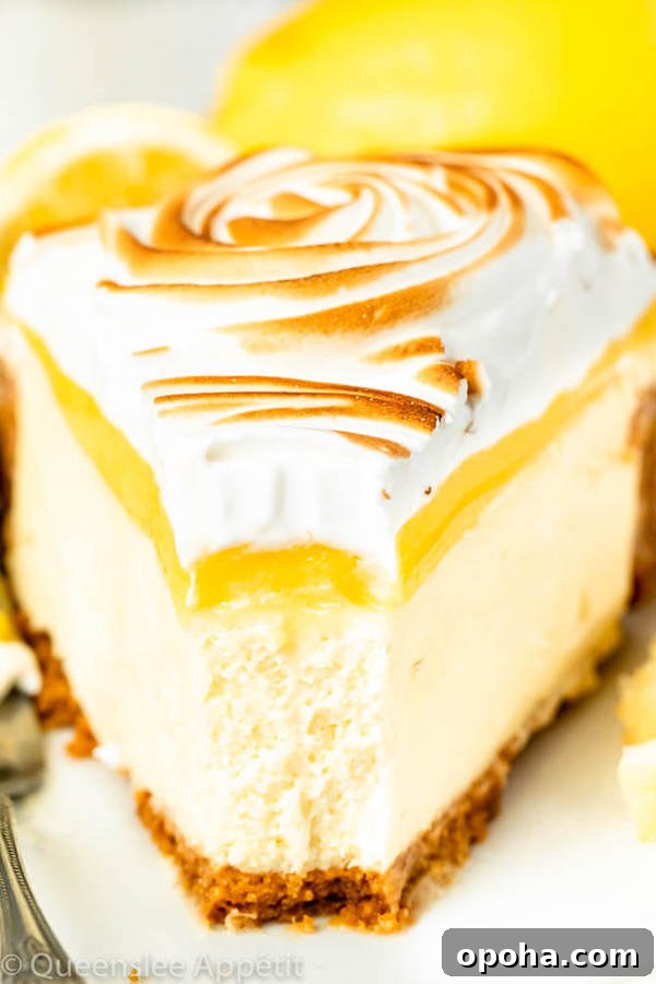 lemon meringue cheesecake with graham cracker crust, lemon cheesecake, lemon curd topping, meringue rosettes