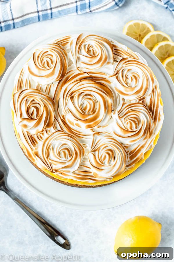 lemon meringue cheesecake with graham cracker crust, lemon cheesecake, lemon curd topping, meringue rosettes