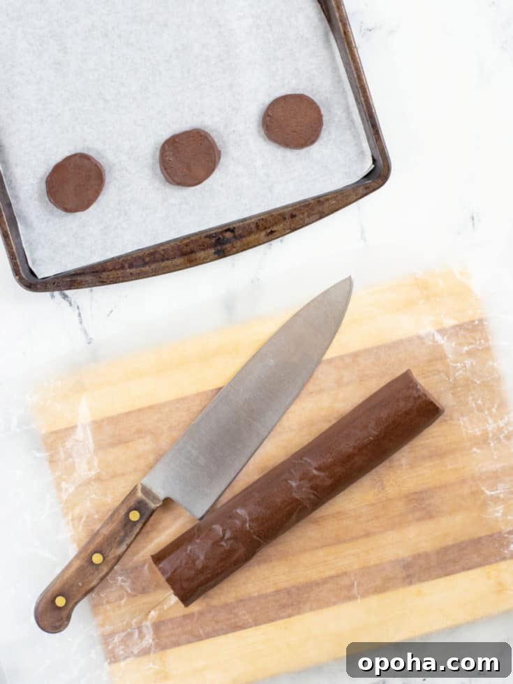 Chocolate Icebox Cookies Recipe — Perfect for Decorating 2 Chocolate cookies sliced on cookie sheet