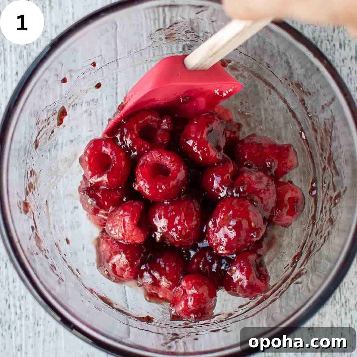 Raspberry Danish Recipe: Flaky Pastry with Fresh Raspberry Filling 4 Stirring fresh raspberries with raspberry jam in a glass bowl.
