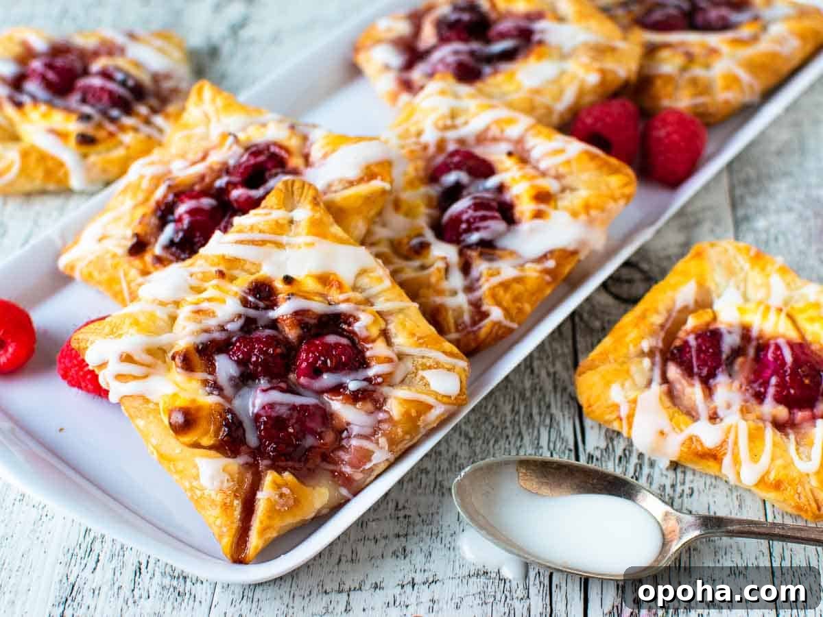 Raspberry Danish Recipe: Flaky Pastry with Fresh Raspberry Filling 9 Close up of puff pastry danish with raspberry filling.
