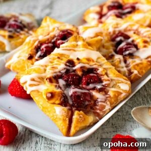 Raspberry Danish Recipe: Flaky Pastry with Fresh Raspberry Filling 10 Raspberry Danish pastries on white plate.