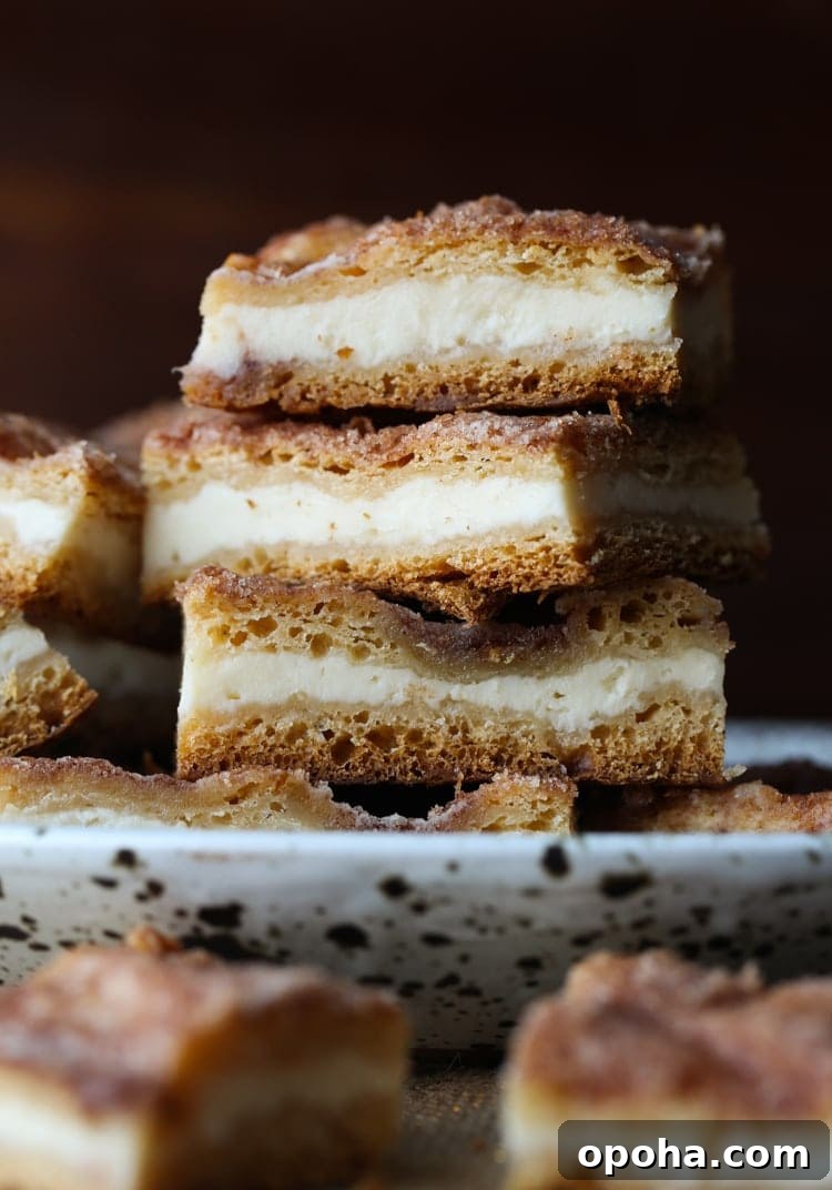 Sopapilla Cheesecake Bars Three Sopapilla cheesecake bars stacked on a plate.