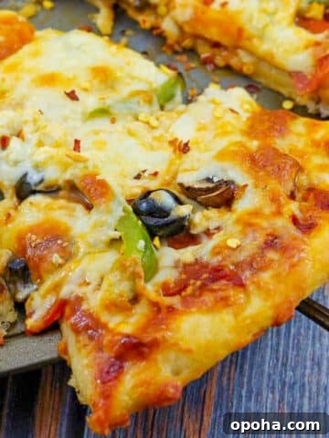 slice of weight watchers pizza being lifted off a pizza pan