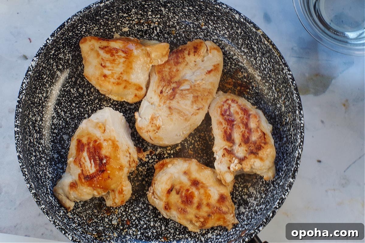 5 cooked chicken breasts in a frying pan