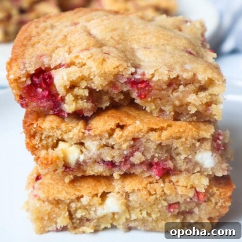 3 white chocolate chip raspberry blondies stacked on one another