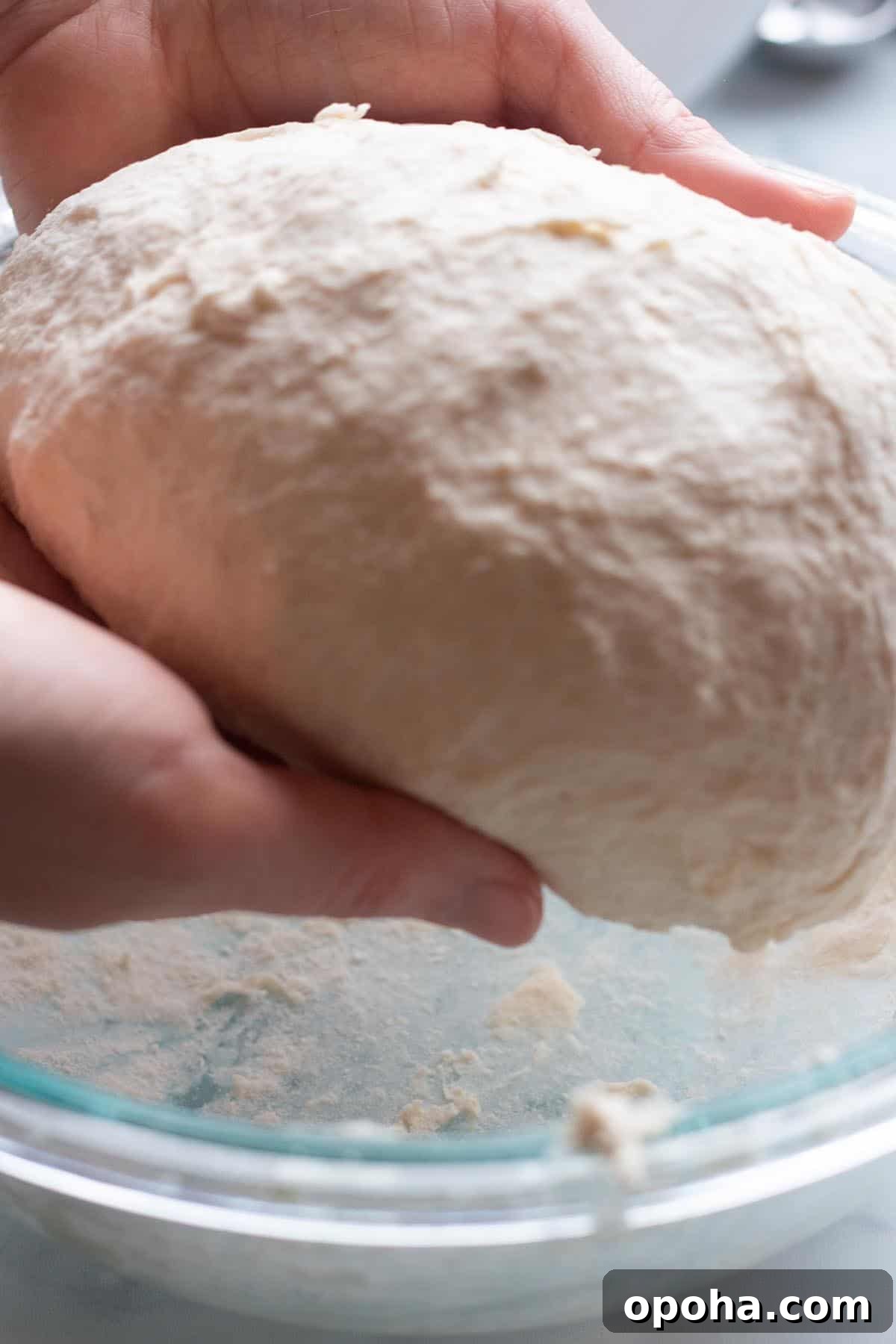 Sourdough Discard Naan Recipe: Crispy, Chewy Flatbread 4 Two hands forming a ball of sourdough naan.