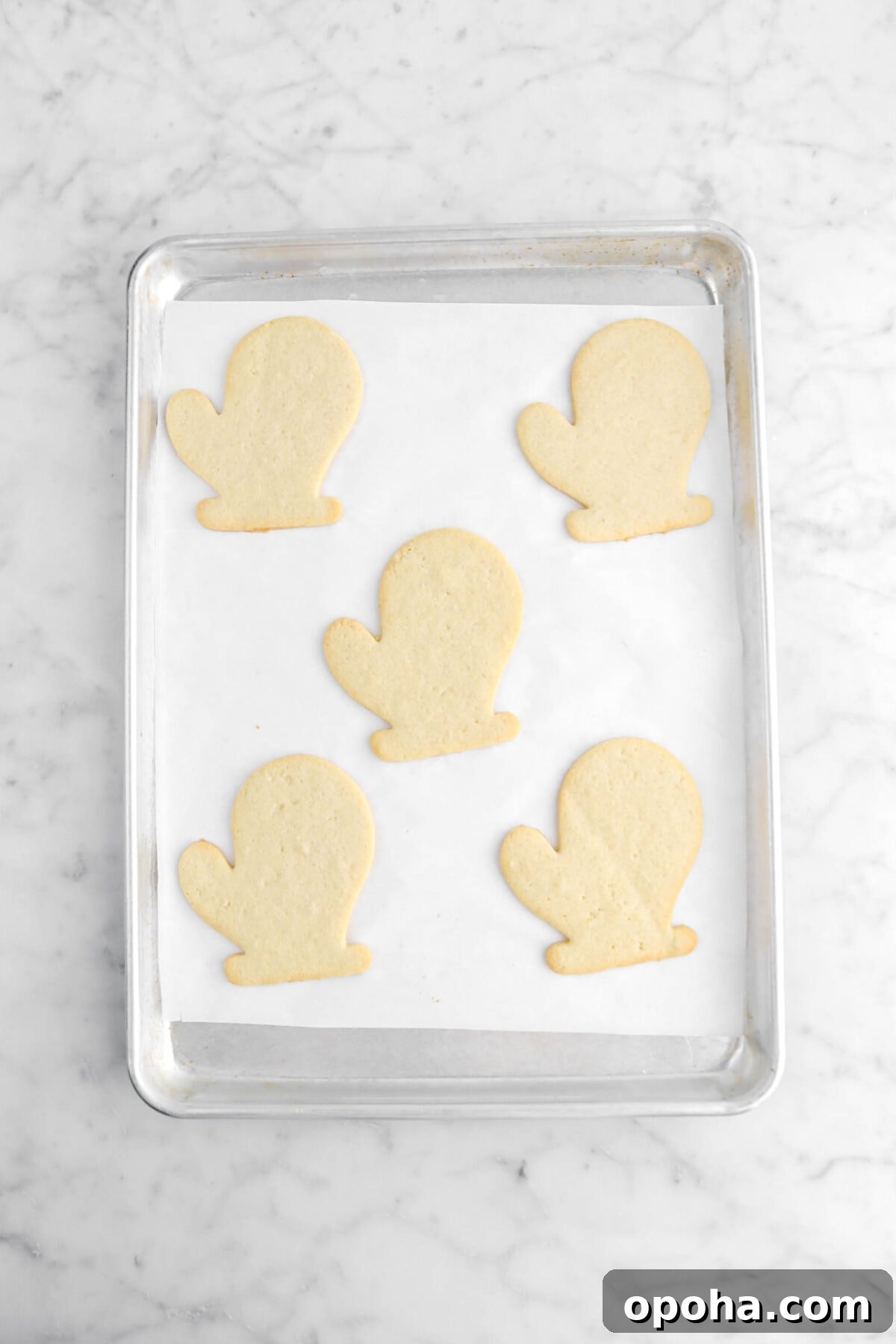 Santa’s Glove Peppermint Sugar Cookies: Festive Holiday Recipe 14 five baked cookies on lined sheet pan.