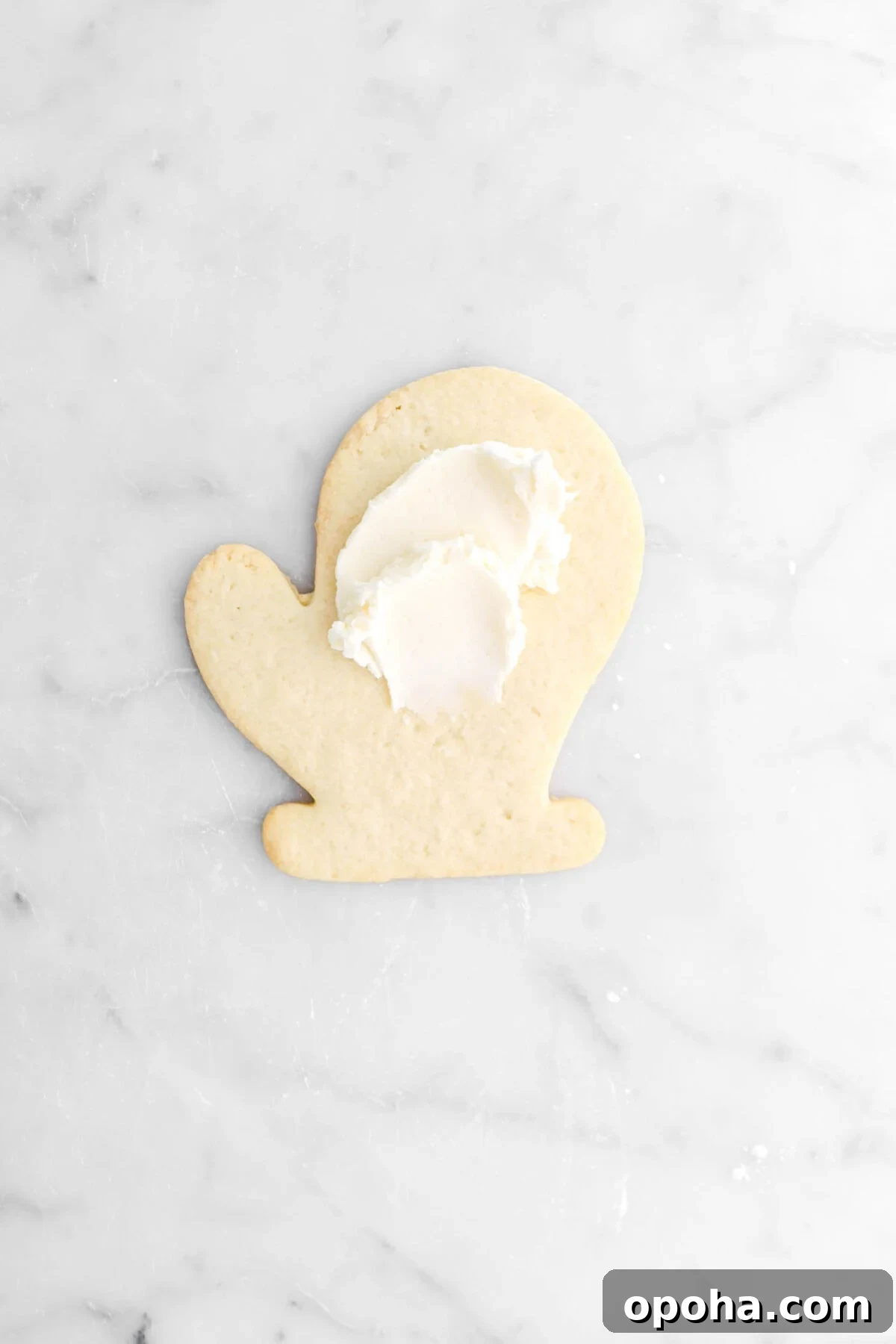 Santa’s Glove Peppermint Sugar Cookies: Festive Holiday Recipe 17 butter cream dolloped onto cookie.