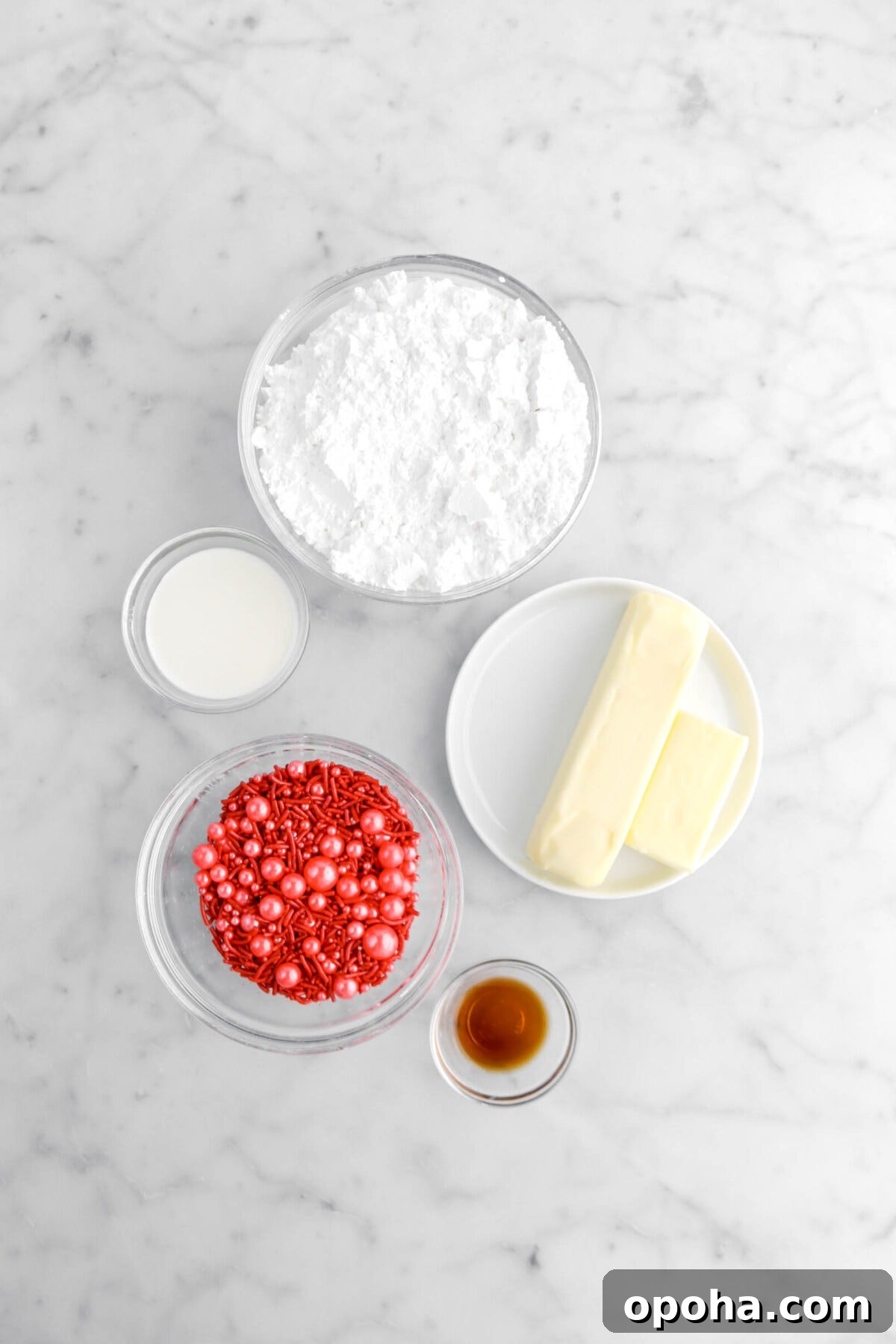 Santa’s Glove Peppermint Sugar Cookies: Festive Holiday Recipe 8 powdered sugar, milk, butter, vanilla, and red sprinkles on marble surface.