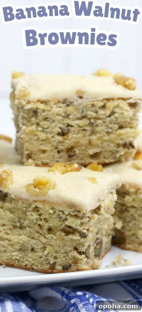 four banana walnut brownies stacked on a square plate.
