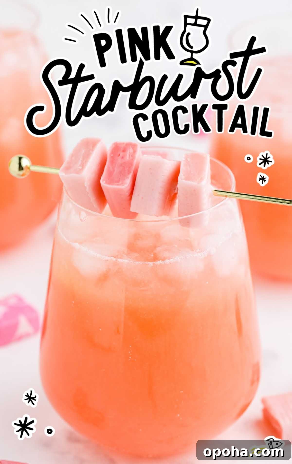 Close-up of a vibrant pink starburst cocktail with ice and candy garnish on a cocktail pick.