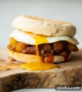 close up shot of potato sandwich on chopping board with yolk dripping out